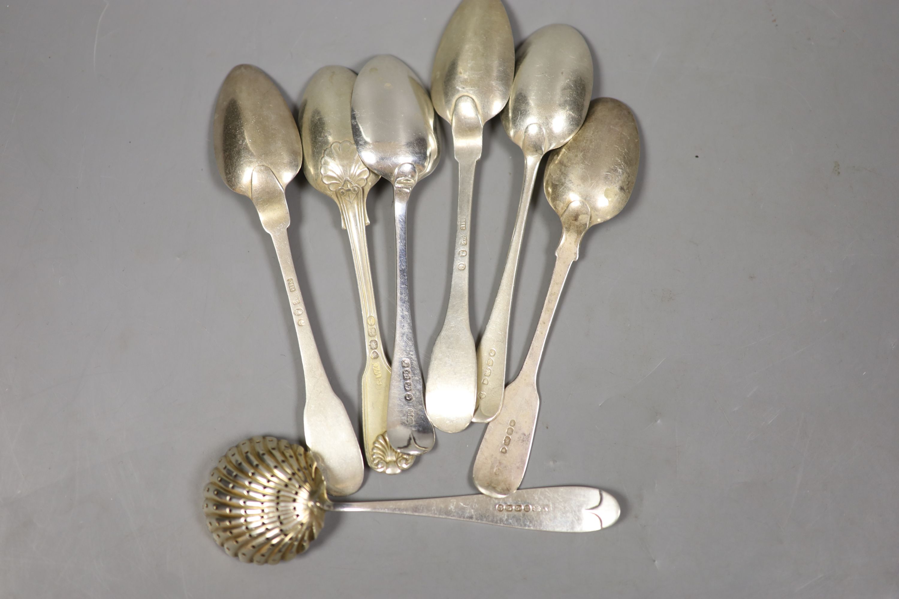 Seven assorted 19th century silver spoons including teaspoons and a sifter spoon, various dates and makers